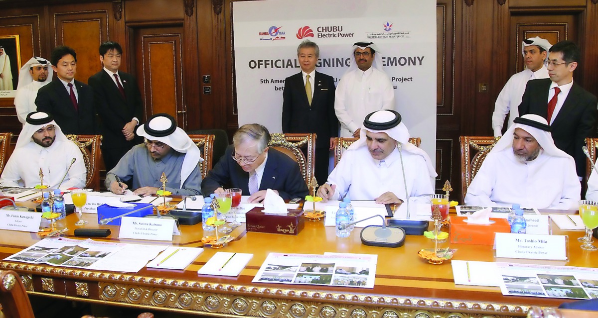 Minister of Energy and Industry H E Dr Mohammed bin Saleh Al Sada (standing at the back) witnessing the signing ceremony for the  5th amendment of the MoU of ‘The Partnership Project’ among QEWC, Kahramaa and Japan's Chubu at the Ministry's headquarters,