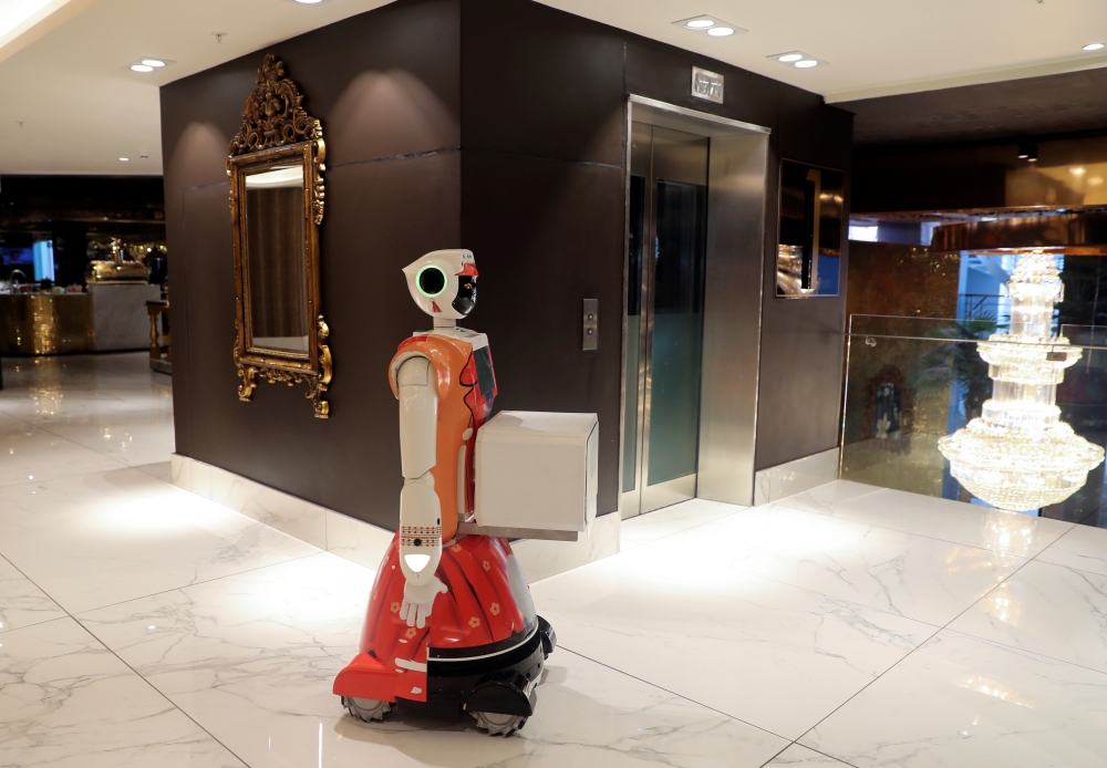 AI-powered robot Ariel stands outside a lift before delivering room service at the Hotel Sky, the first in Africa to use automated attendants, in Johannesburg, South Africa, February 9, 2021. Picture taken February 9, 2021. REUTERS/ Sumaya Hisham