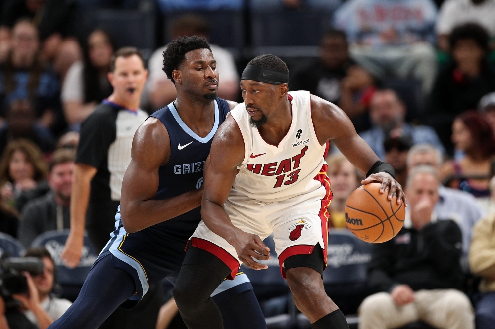 Bam Adebayo #13 of the Miami Heat handles the ball against Jaren Jackson Jr. #8 of the Memphis Grizzlies during the second half at FedExForum on October 24, 2025 in Memphis, Tennessee. Justin Ford/Getty Images/AFP