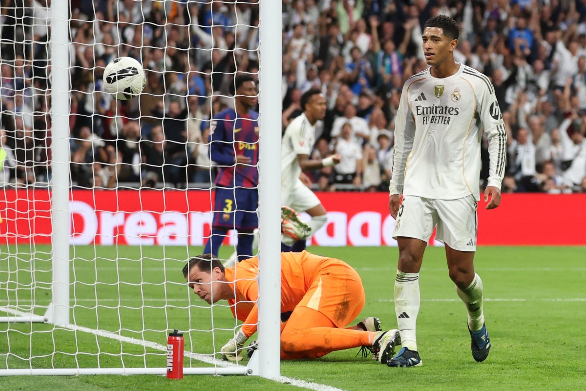 Real Madrid's English midfielder #05 Jude Bellingham scores his ream's second goal during the Spanish league football match between Real Madrid CF and FC Barcelona at Santiago Bernabeu Stadium in Madrid on October 26 , 2025. (Photo by Oscar DEL POZO / AFP)
